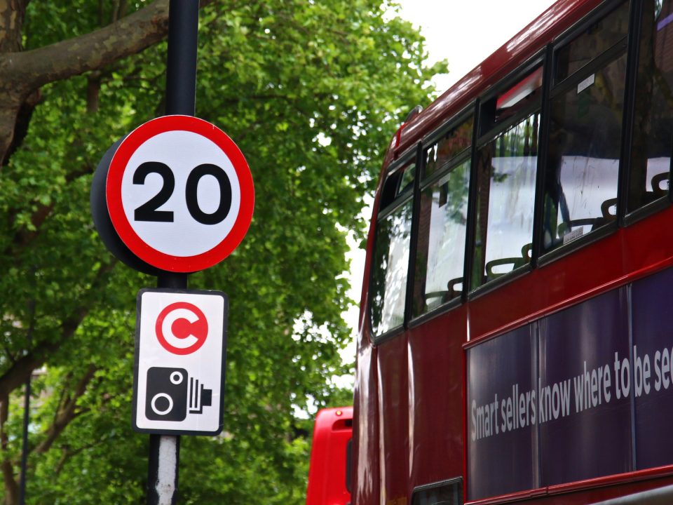 London bus next to a 20 mph speed sign